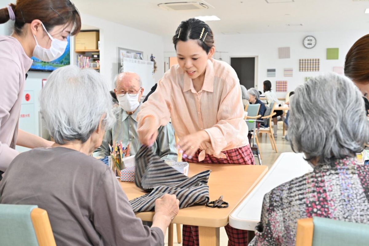 遠州綿紬の生地を手に取るワークショップの参加者